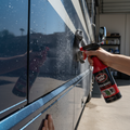 Turtle Wax ceramic spray coating being applied to RV exterior with water beading effect